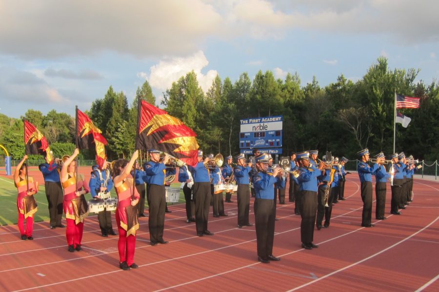 The Royal Guard and the band perform at halftime during the football game.