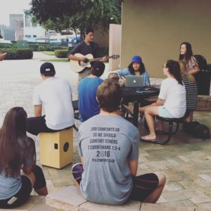 Upper School students leading worship in the Alumni Commons