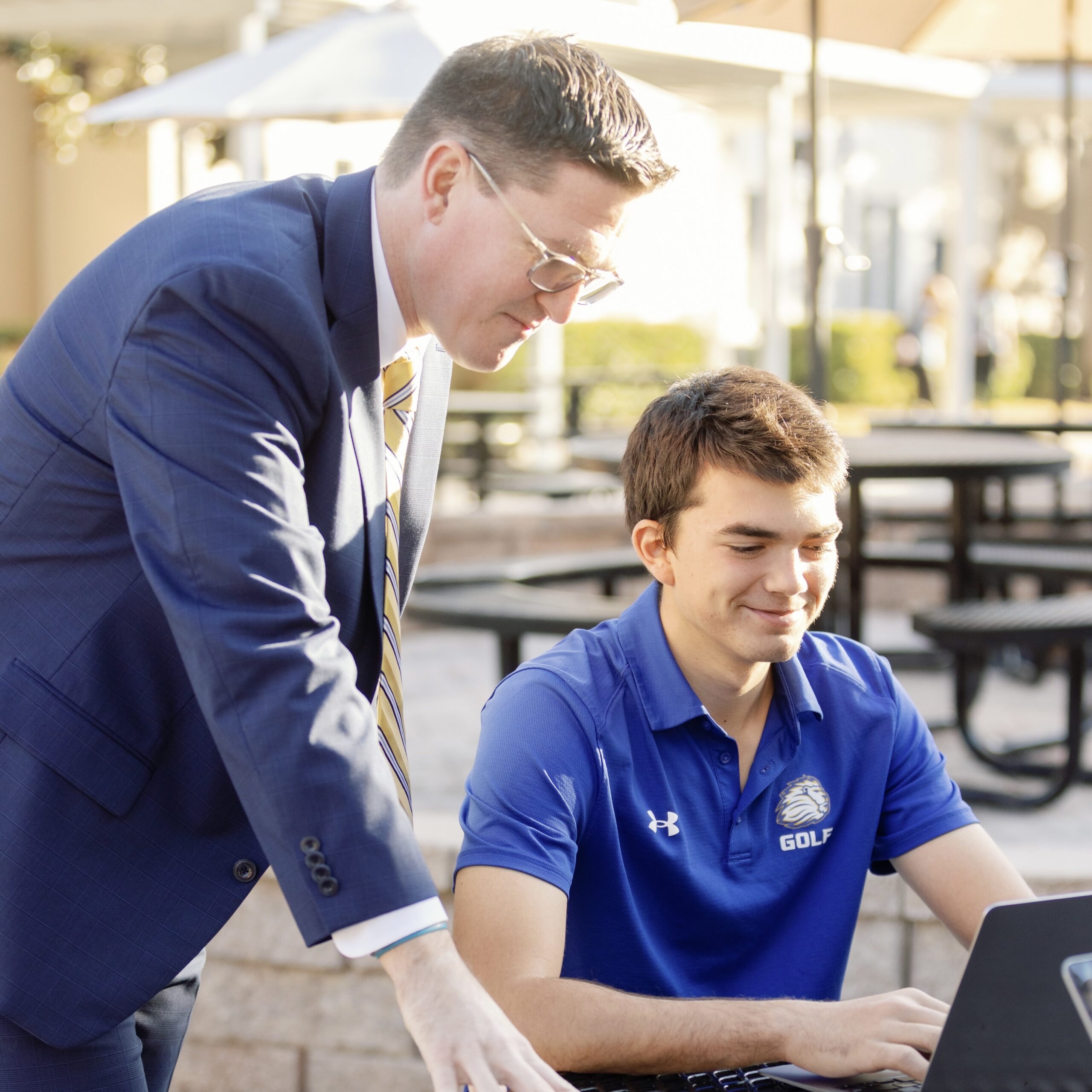 Two students looking down at their tablets as they complete a class assignment